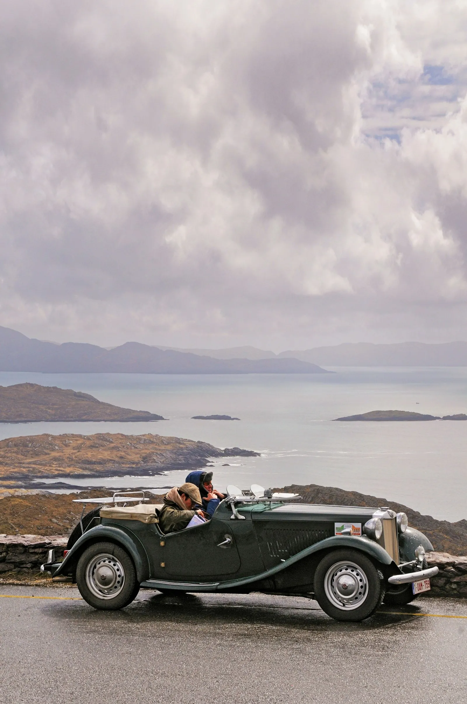 A vintage car on a coastal road